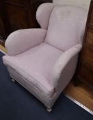 A pair of 1930's club style wing armchairs on silvered feet