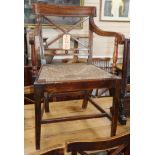 A set of six Regency fruitwood and rush seated chairs, including one carver