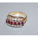 An 18k gold ruby and diamond triple row ring, size S