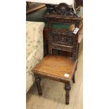 A Victorian carved oak hall chair