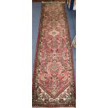 A Persian red ground runner 304 x 77cm