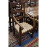 A set of ten 17th century style oak dining chairs (two having arms), with drop-in rush seats