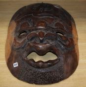 Three large carved Kenyan hardwood masks longest 70cm