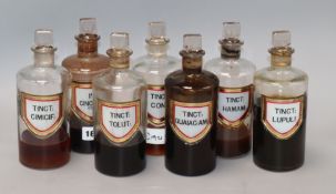 A collection of seven late Victorian chemist's liquid drug jars and stopper, with gilt framed