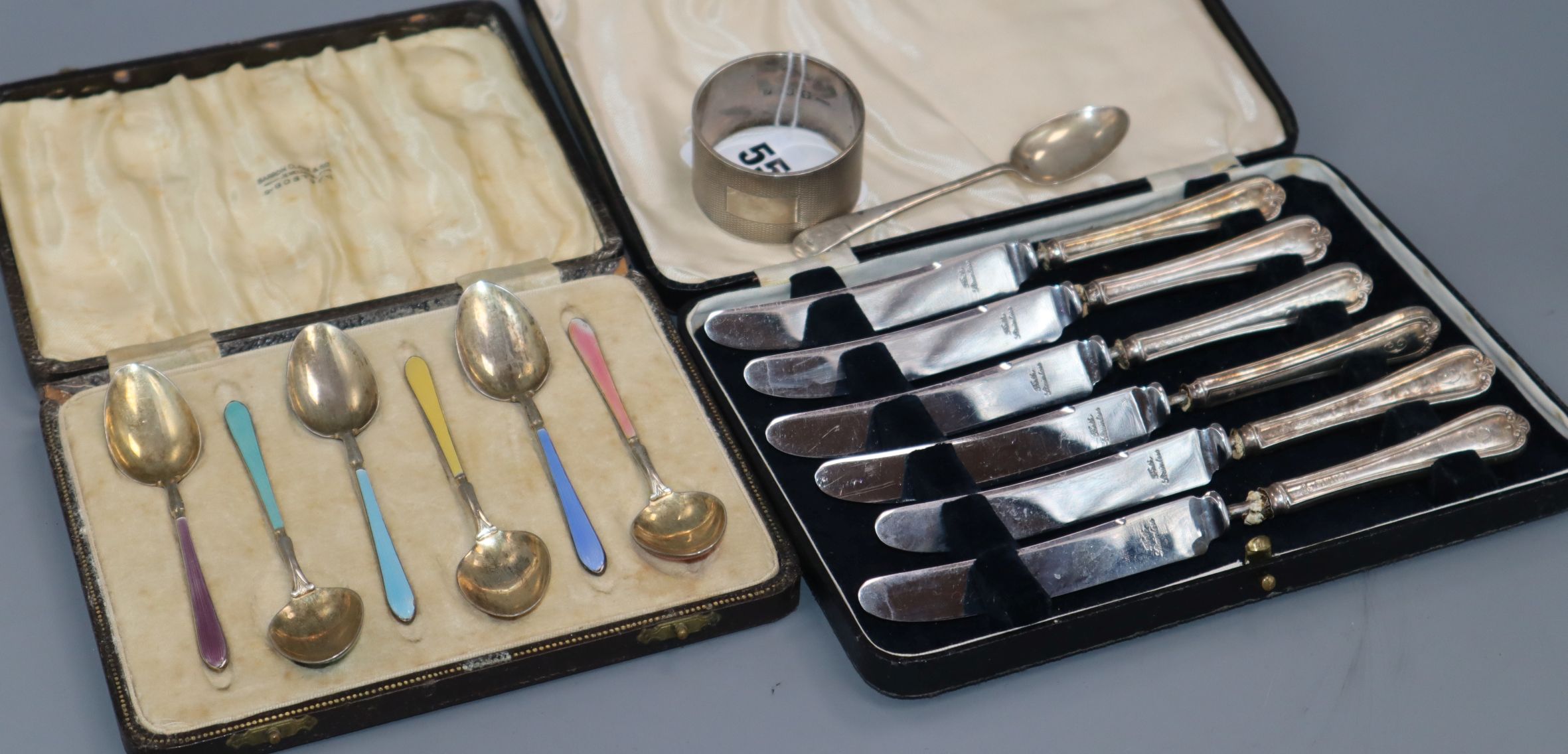 A cased set of six George V enamelled silver coffee spoons, a set of six silver handled tea