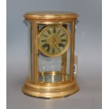 A 19th century French gilt brass four-hour mantel clock, of oval form, with silvered dial height