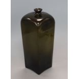 A tall late 18th century dark green glass wine bottle, of square section height 30cm