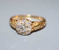 A gold and diamond cluster ring, size O