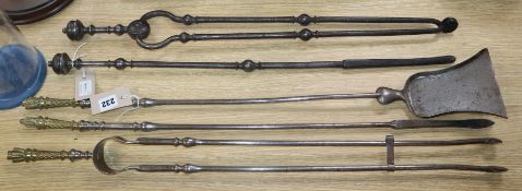 A set of three Regency steel fire implements with stylised 'quiver' handles and two other steel fire