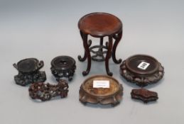 A group of seven Chinese carved wood stands, 19th / 20th century