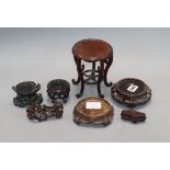 A group of seven Chinese carved wood stands, 19th / 20th century