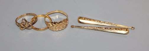 A 22ct gold wedding band, 2.6 grams, an unmarked gold knot ring, another ring and a pair of drop