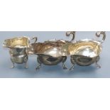 A matched pair of silver cream boats with shaped rims and C-scroll handles, London 1899/1900, 16oz