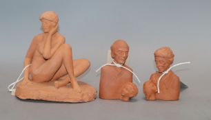 A terracotta model of a seated nude by Eric Griffiths and two similar double busts