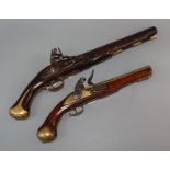 An early 19th century 'London' flintlock pistol and a replica flintlock pistol