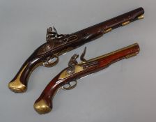 An early 19th century 'London' flintlock pistol and a replica flintlock pistol