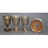 Three silver goblets by Mappin & Webb and a Merchant Taylors Company bottle coaster, 17oz (