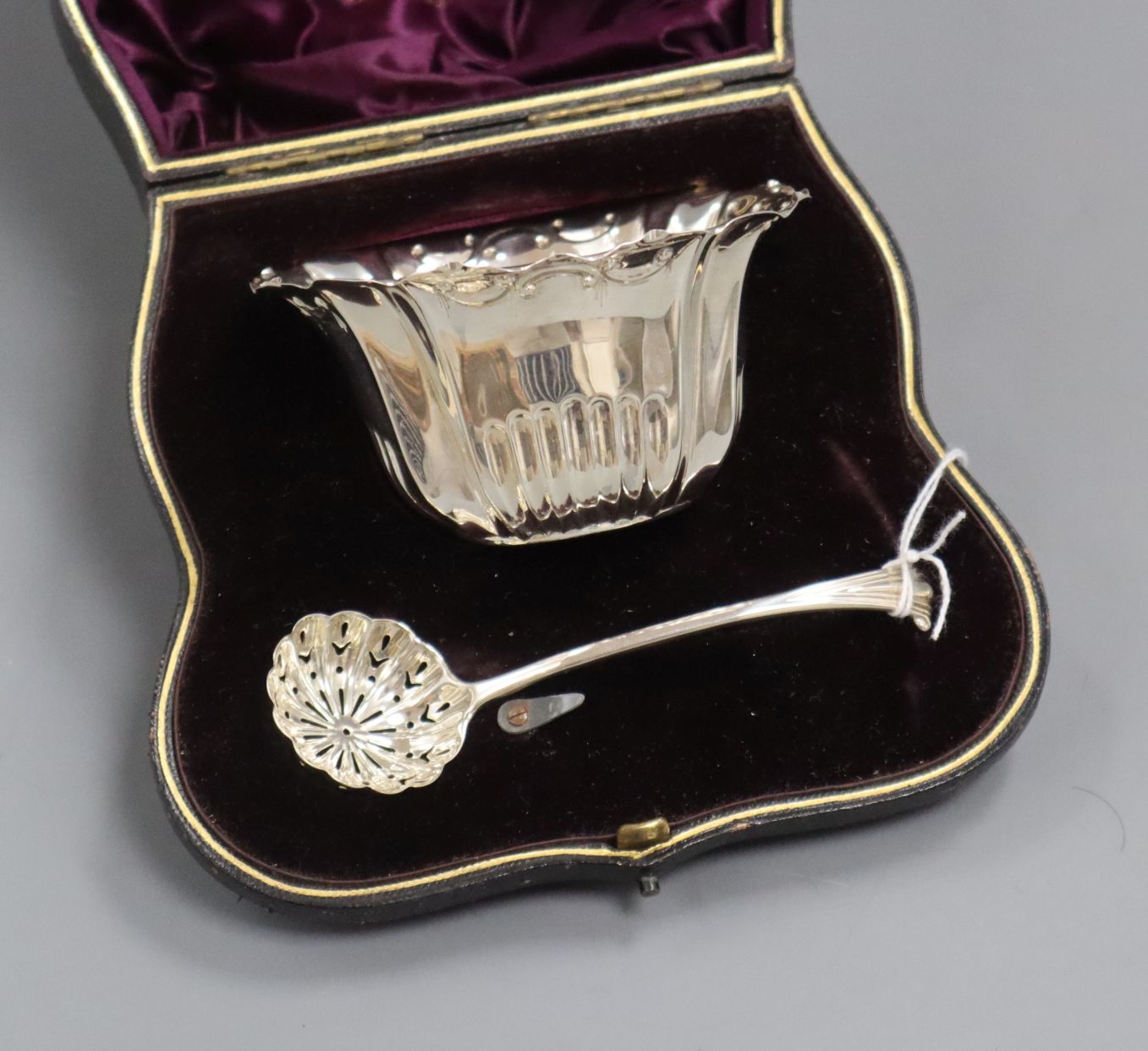 A late Victorian silver sifter, ladle and bowl christening set, in fitted leather case, London 1896
