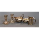 A pair of George V silver dwarf pillar candlesticks (weighted), two silver sauce boats and a