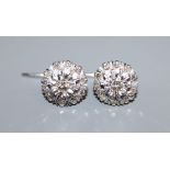 A pair of white gold and diamond illusion set cluster earrings, diameter 11.5mm