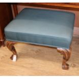 A Queen Anne style walnut stool, with green upholstery, carved cabriole legs and scrolled feet H.