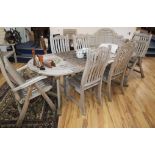 A teak garden table and six chairs Table W.124cm