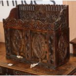 A heavily carved oak cabinet with two sliding doors W.60cm