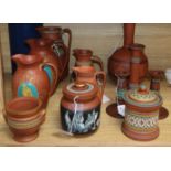 A collection of Etruscan-style redware, including a black-figured bottle-shaped vase, a similar jug,