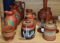 A collection of Etruscan-style redware, including a black-figured bottle-shaped vase, a similar jug,