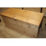 A Victorian pine trunk with hinged top W.112cm