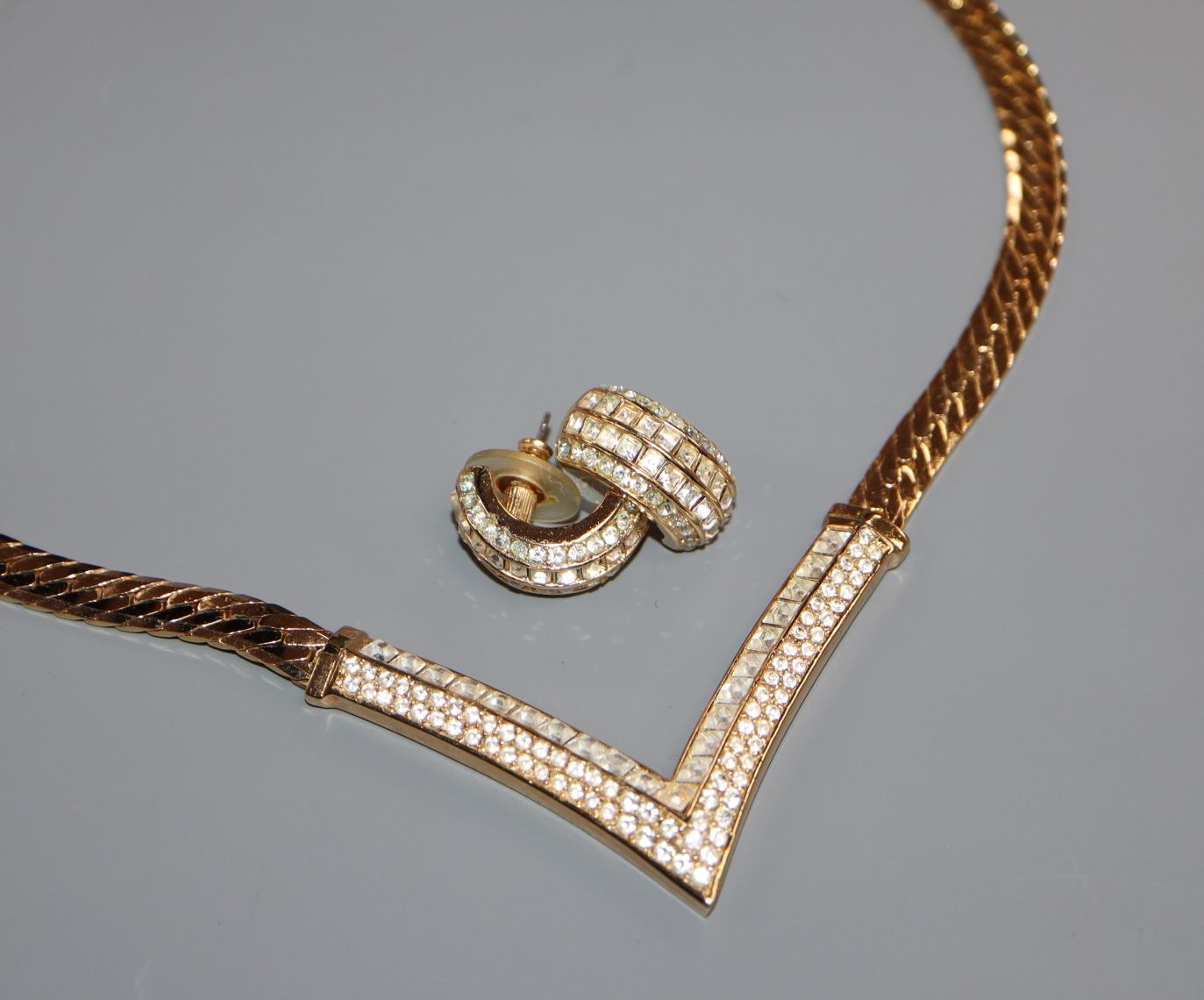 A Christian Dior chevron gilt metal and paste pendant necklace and matching earrings