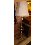 An Edwardian wrought iron brass standard lamp
