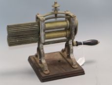 A Victorian brass and cast iron table top crimping machine, possibly for pea shelling