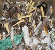 A large collection of plated cutlery, including a soup ladle, a cheese scoop, carving implements