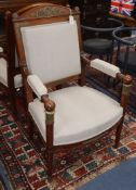 A pair of Empire-style mahogany elbow chairs