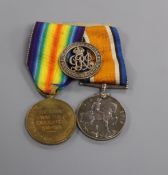 A pair of WWI medals and wound badge