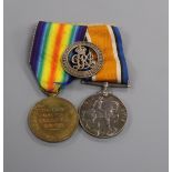 A pair of WWI medals and wound badge