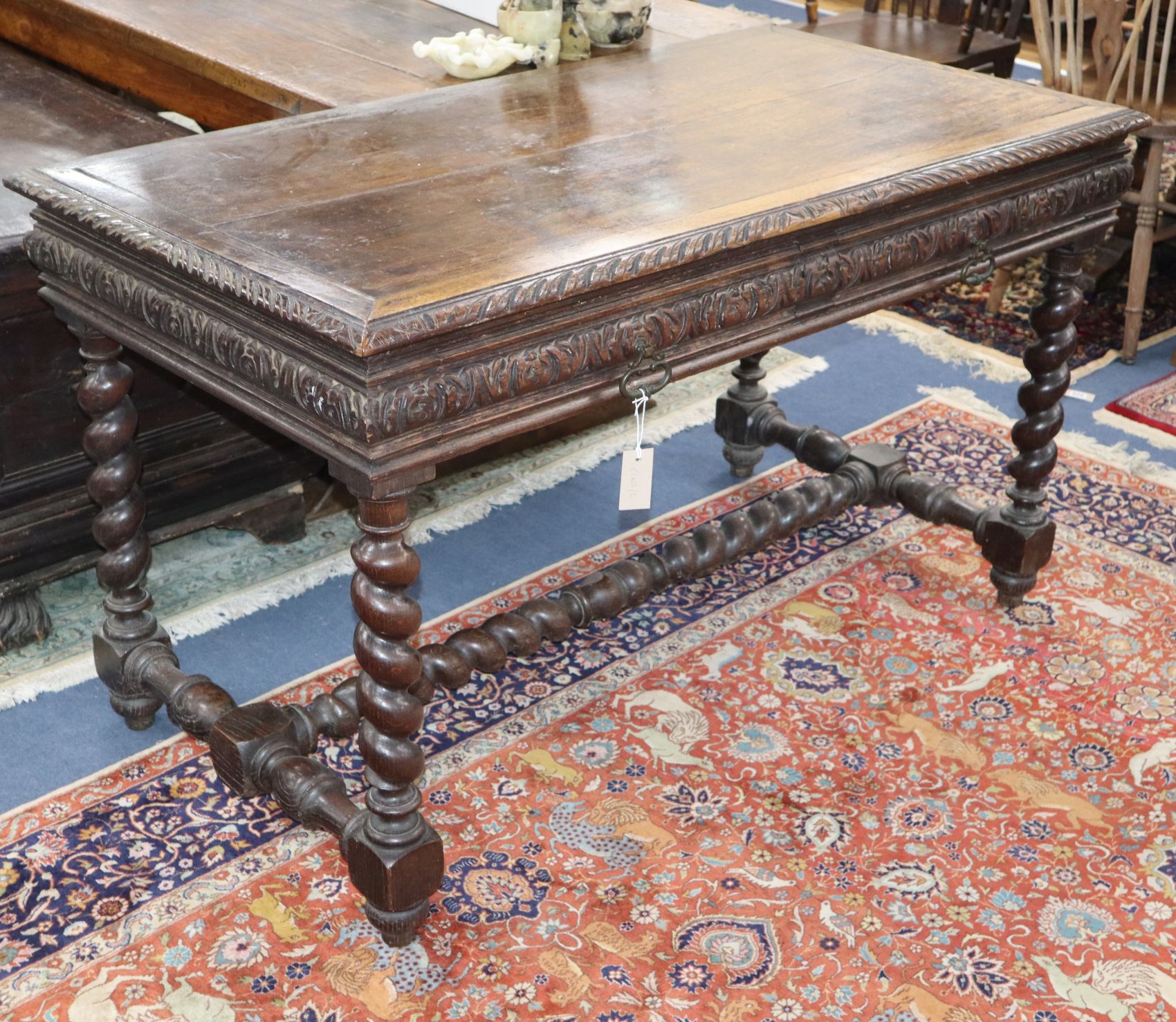 A Flemish style carved oak two drawer serving table W.130cm