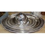Four plated oval meat dishes, a large plated meat dish with a shaped border and a muffin dish and