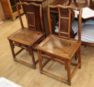 A pair of Chinese elm yoke back chairs