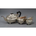 A George V three piece silver teaset, of rounded rectangular form, by Walker and Hall, Sheffield