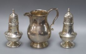 A modern silver baluster cream jug and a pair of Victorian pepperettes, 7oz.