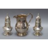 A modern silver baluster cream jug and a pair of Victorian pepperettes, 7oz.