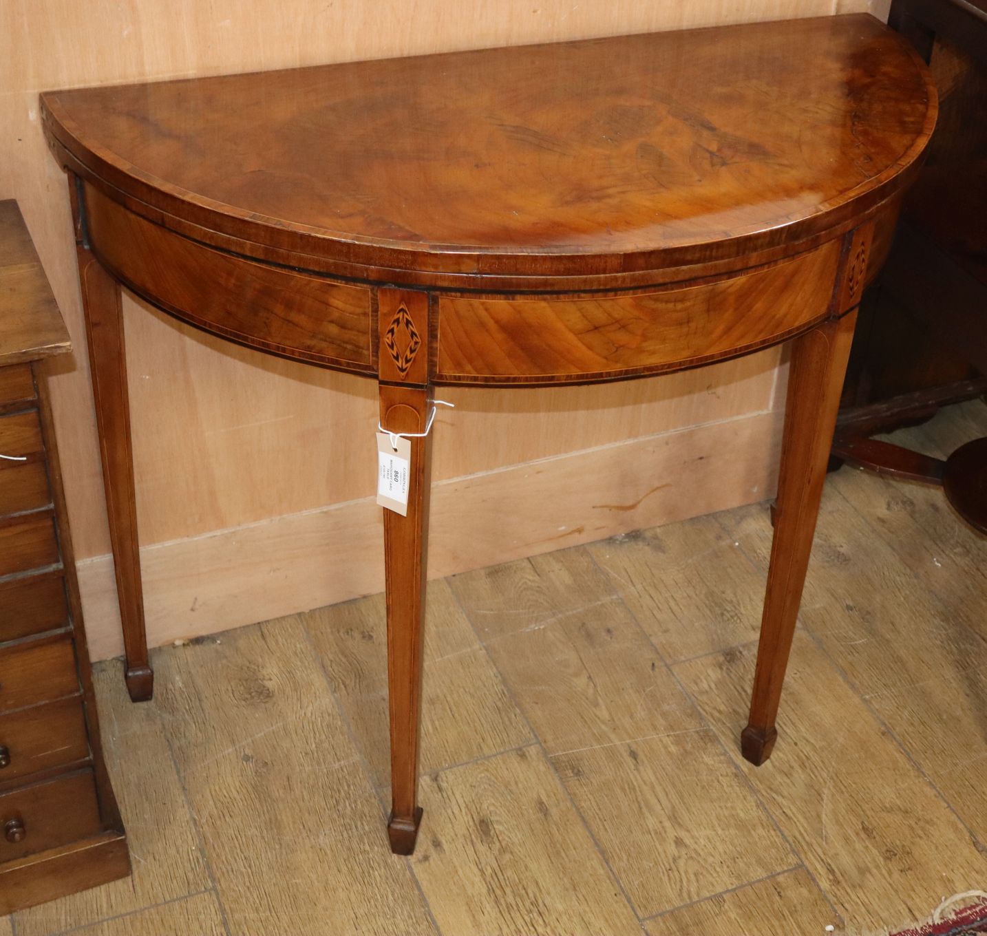 A George III demi-lune inlaid mahogany card table W.90cm