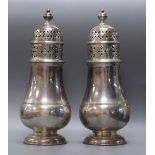 A pair of George V silver baluster castors, London 1933, retailed by Tessiers, 20cm, 17oz