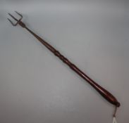 A George III bird roasting fork, with turned mahogany handle