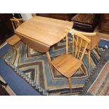 An Ercol drop leaf dining table and four chairs W.113cm