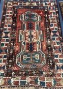 A Kazak red, blue and ivory ground rug 189 x 130cm
