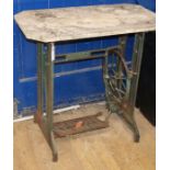 A marble-topped table on a sewing machine base. W.77cm