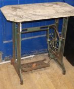 A marble-topped table on a sewing machine base. W.77cm